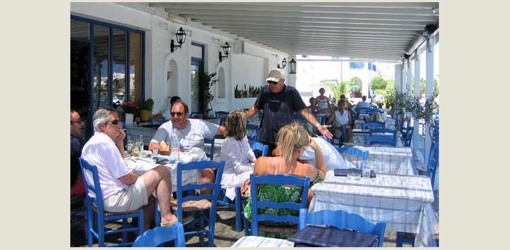 Sit under the covered terrace facing the sea